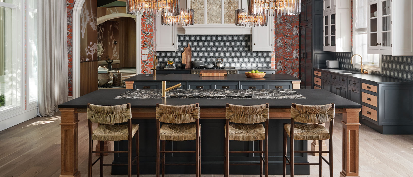 A large kitchen with floral wallpaper, blue tile backsplash and two toned cabinets with Hollinsbrook Matte and Montana Midnight Matte Quartz Countertops