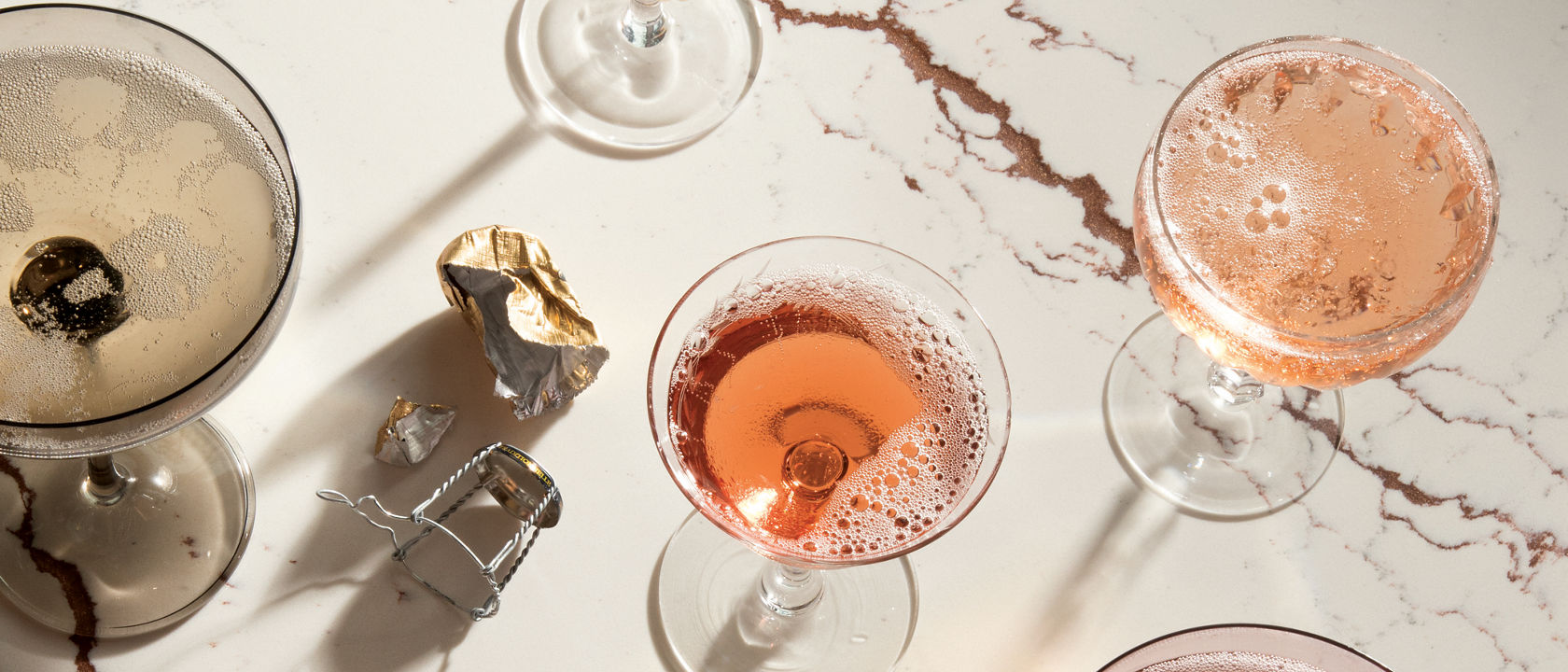 Top-down view of various drinks on top of a Cambria Inverness Bronze Matte quartz countertop.