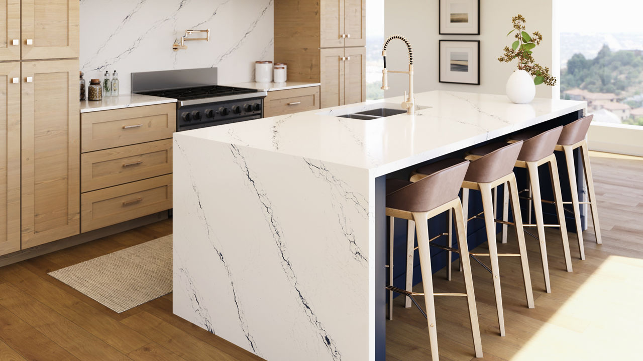 A beautiful tan and cream eat-in kitchen with Cambria Inverness Cobalt quartz countertops and backsplash