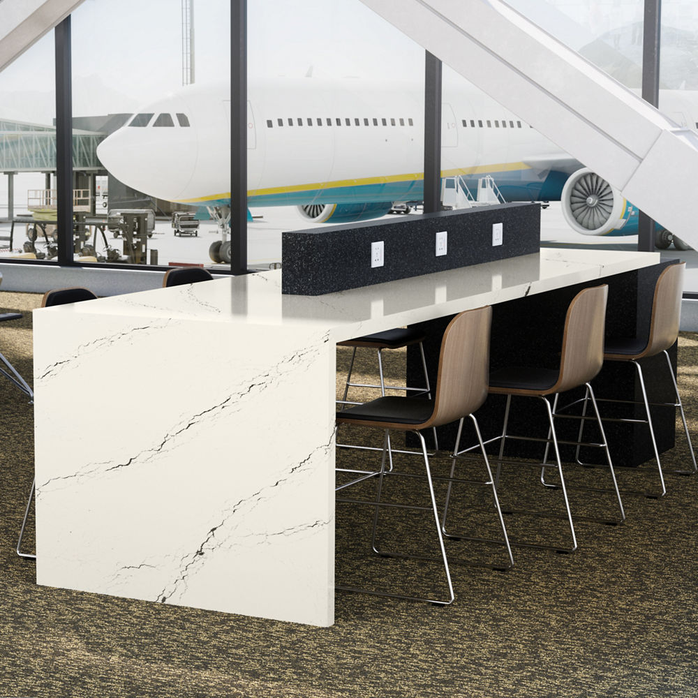 An airport lobby area featuring a Cambria Inverness Platinum desktop