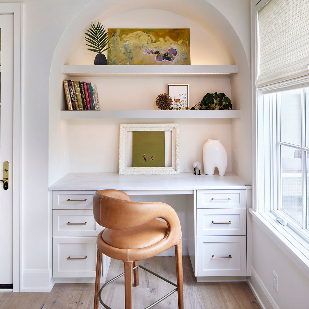 Built in desk with an arched cut out and built in shelving, featuring Cambria Ironsbridge quartz design