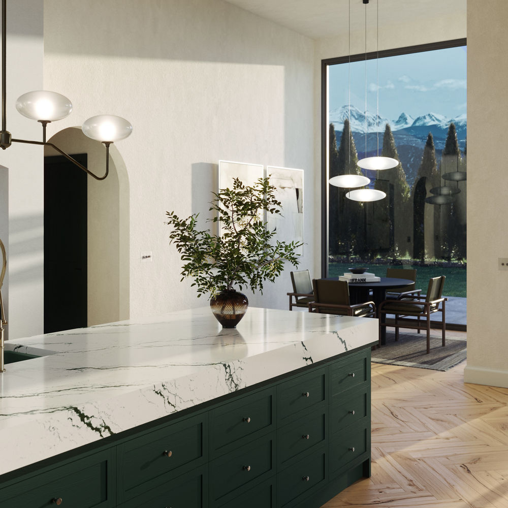 An open kitchen with green cabinets and an Ivybridge quartz island and backsplash