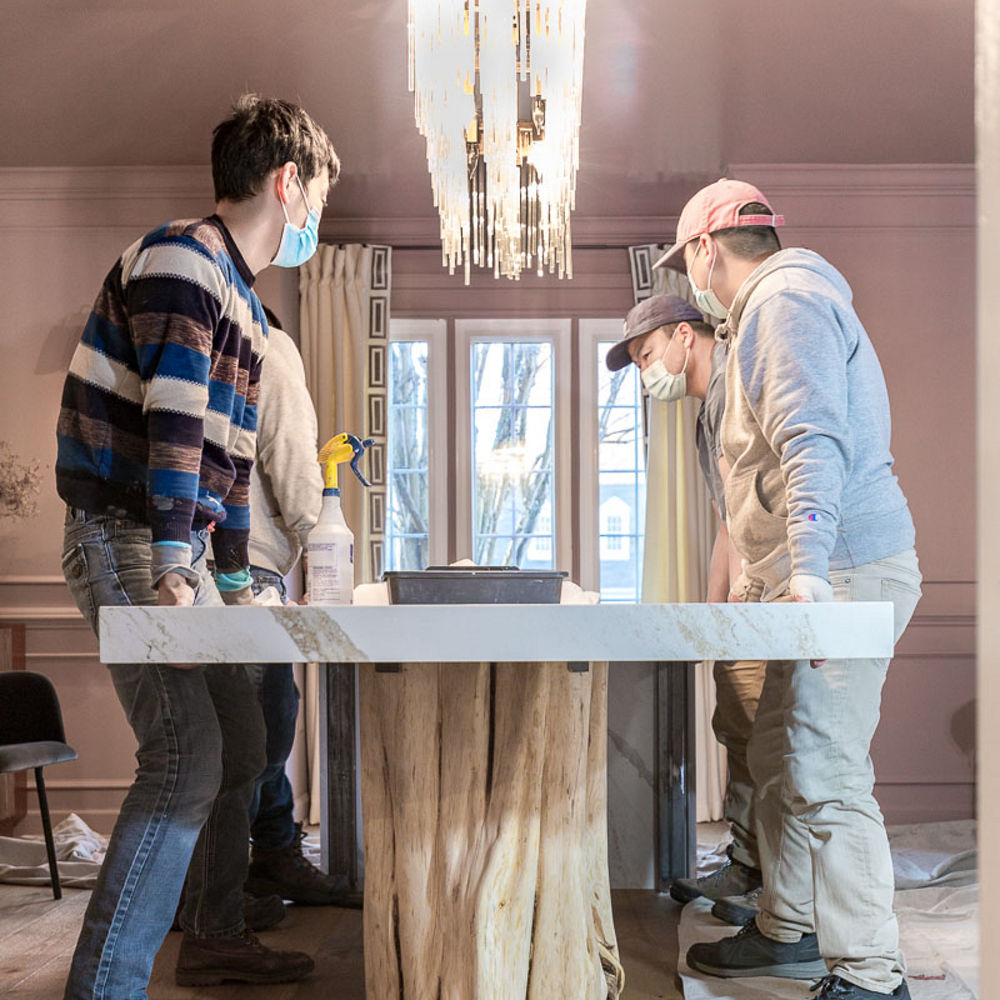 Professionals installing custom dining room table in dining room