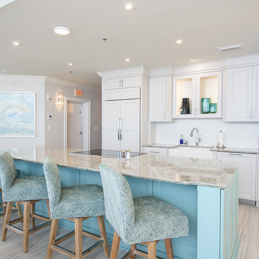 White kitchen featuring island with Cambria Kelvingrove quartz countertops.