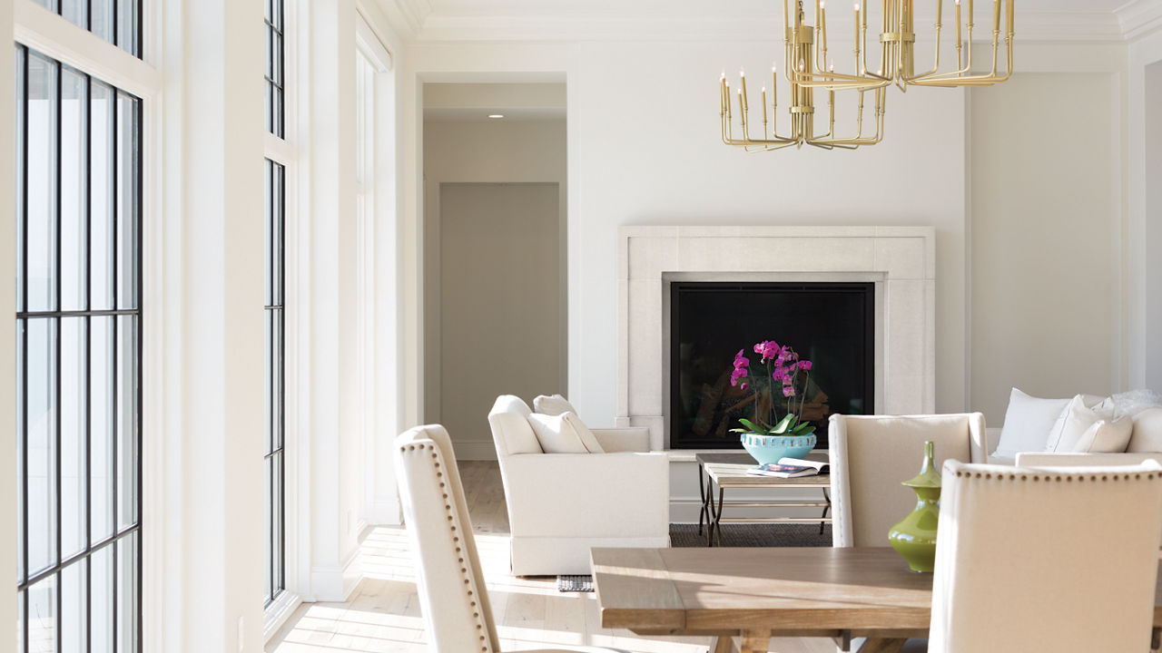 A bright white dining room with a Kirkstead fireplace surround