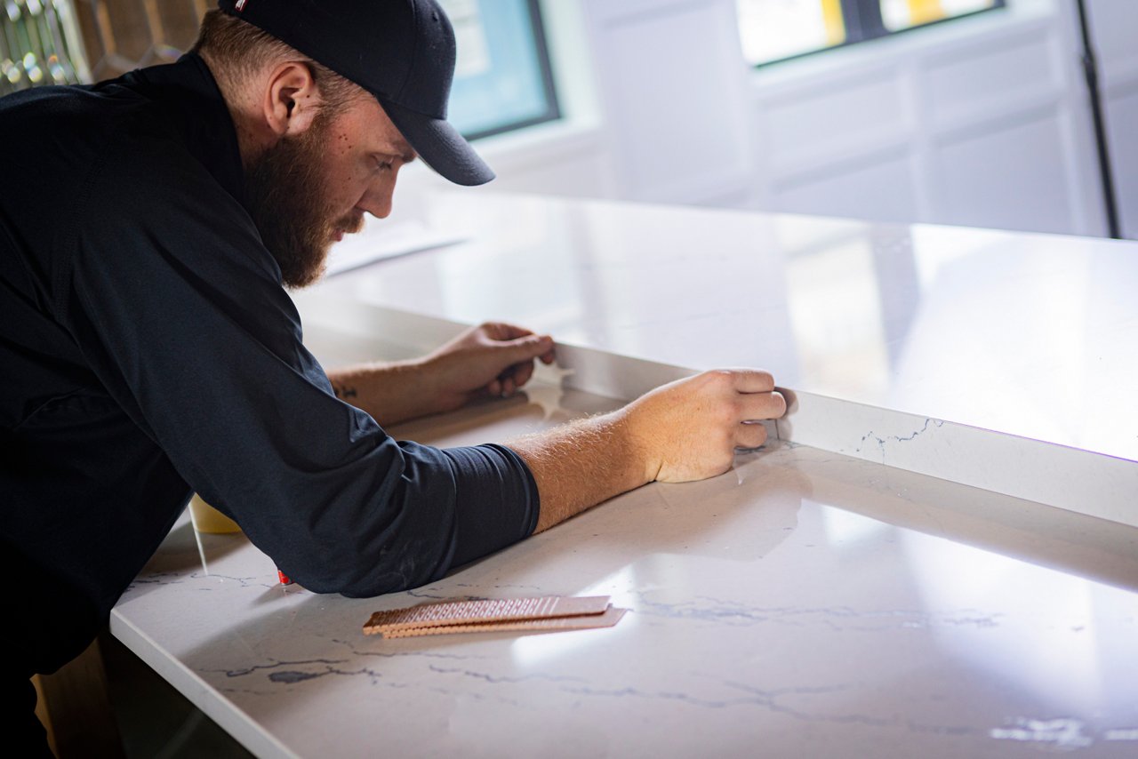 A worker fabricating a Cambria quartz slab