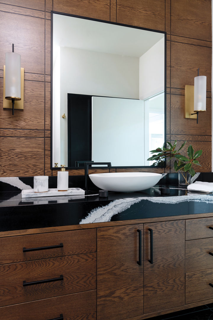A dark bathroom featuring a counter with a Cambria Mersey quartz countertop.