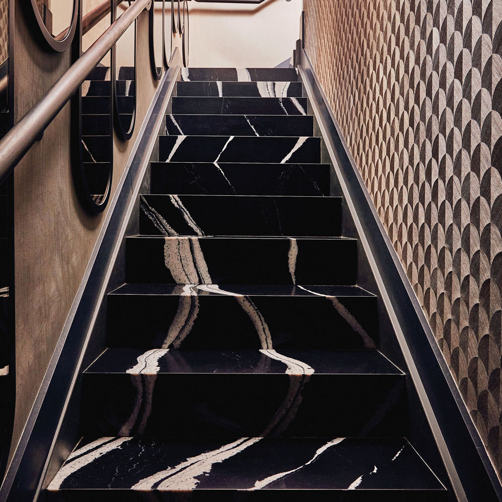Stairs made from Cambria Mersey™ black and white veined quartz countertops.