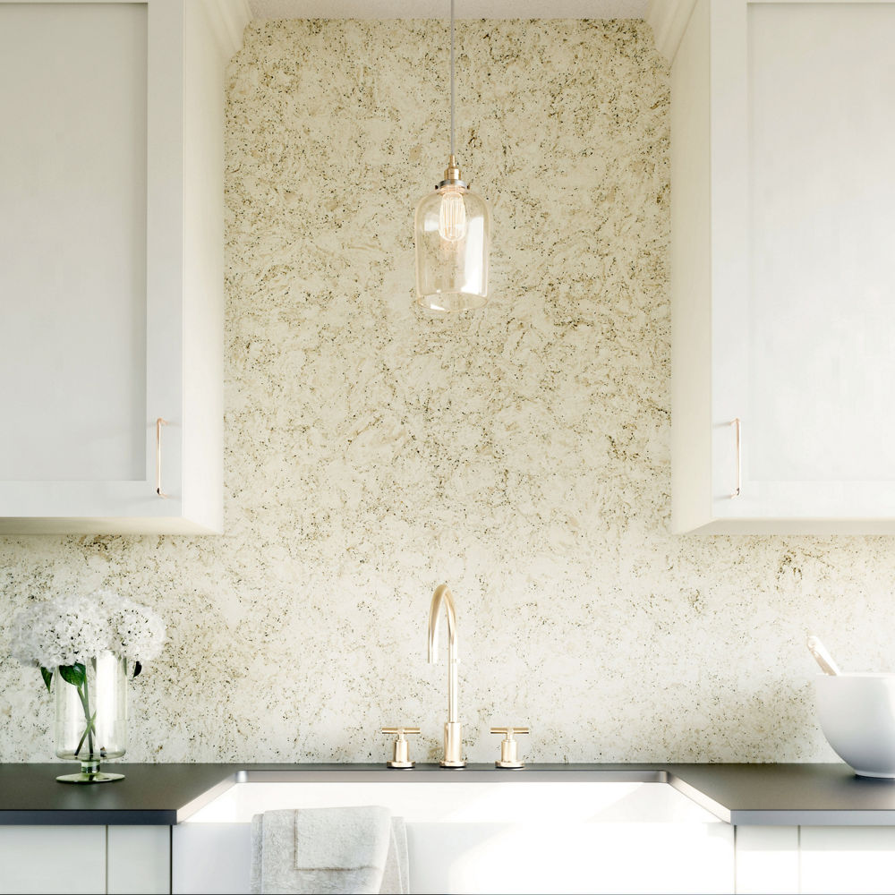 A kitchen with white cabinets and a Pendle Hill quartz backsplash