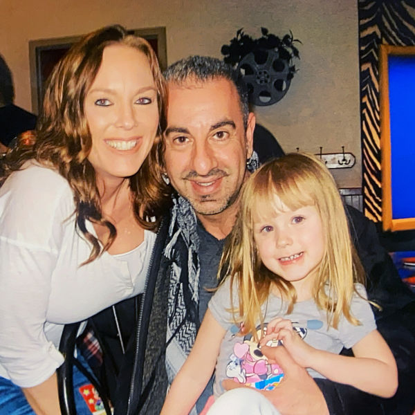 Peter Warda poses for a photo with his wife Regan and their daughter Ava