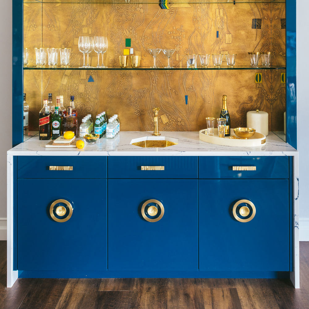 A blue and gold themed bar with Cambria Portrush quartz countertop