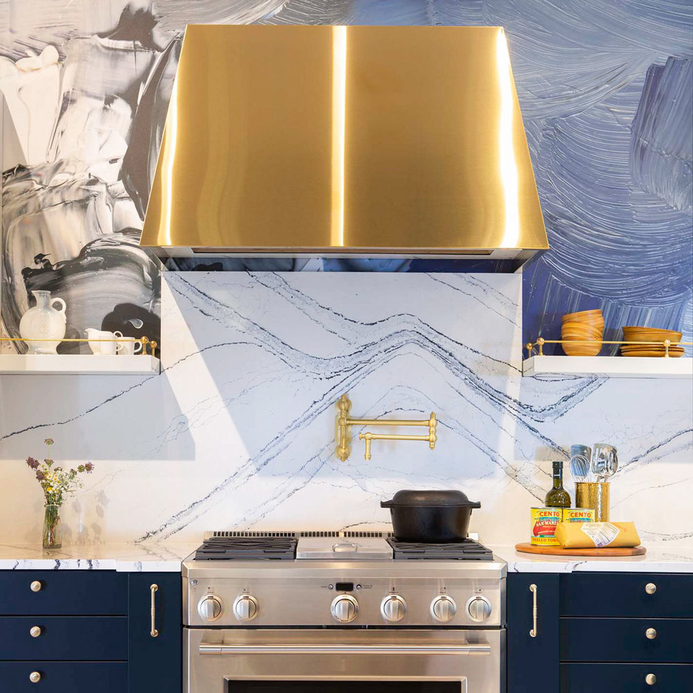 A metallic gold hood and swirling blue and gray wall covering featuring Portrush quartz.