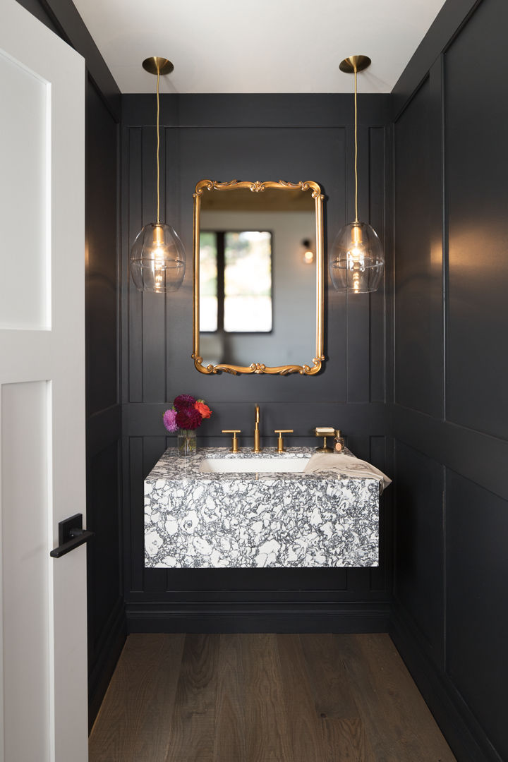 Floating vanity in Cambria Rose Bay with a Kohler sink and faucet, Hennepin Made pendant lights, and paint by Benjamin Moore.