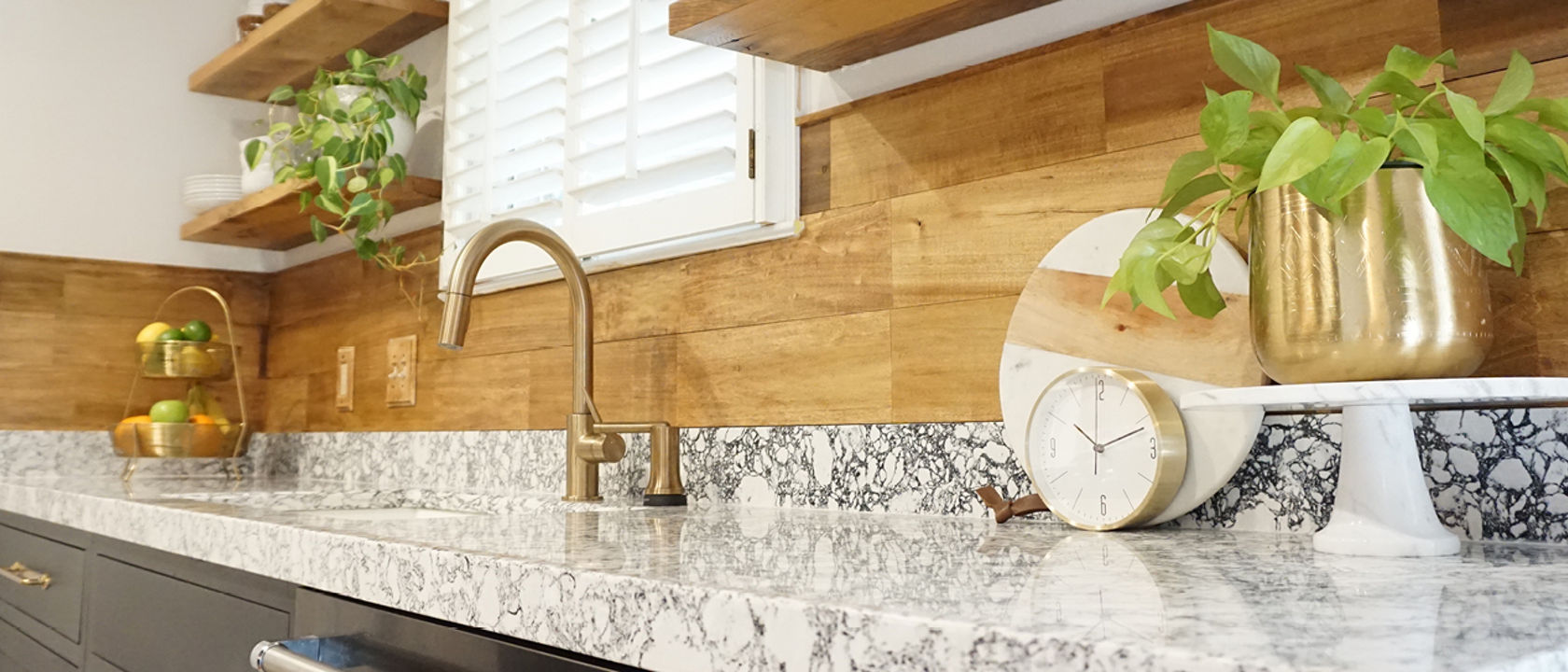 A detailed view of a kitchen counter with a Cambria Rose Bay quartz countertop.
