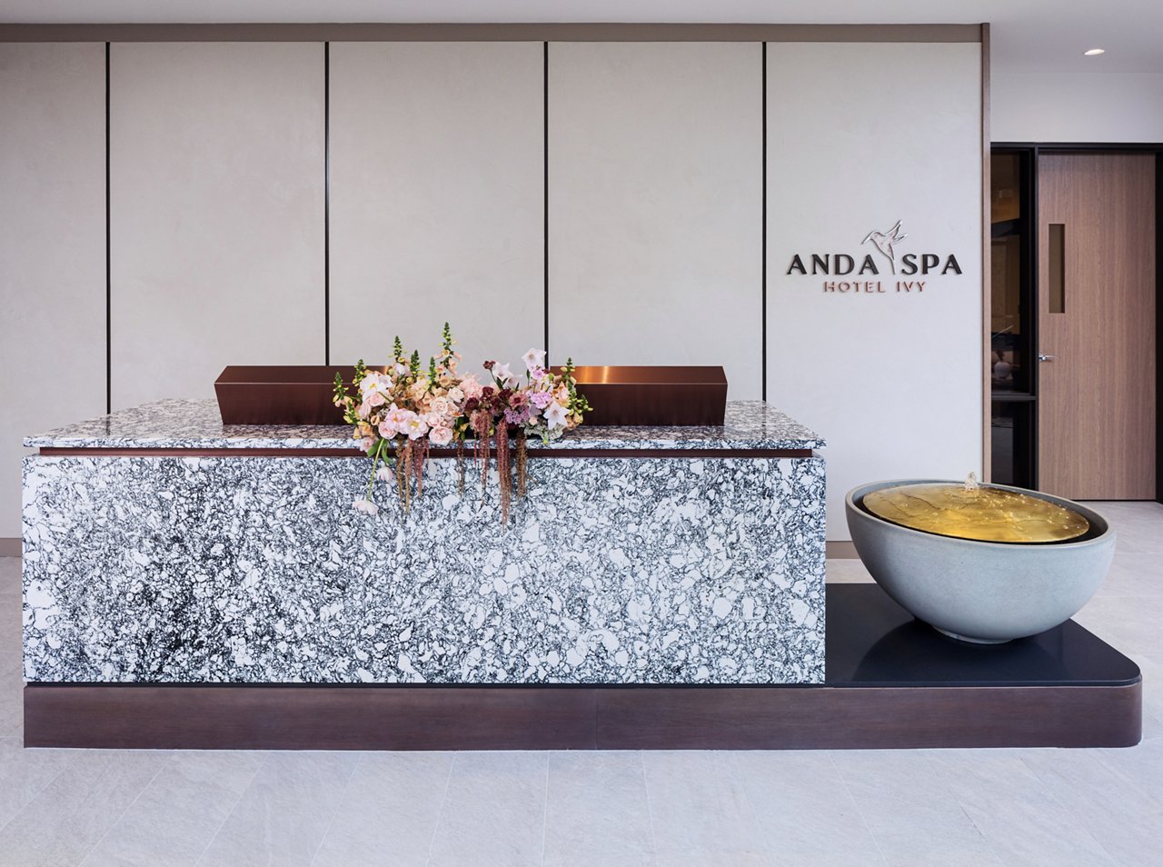 A stunning reception desk made from black and white quartz at the Anda Spa is Minneapolis, Minnesota