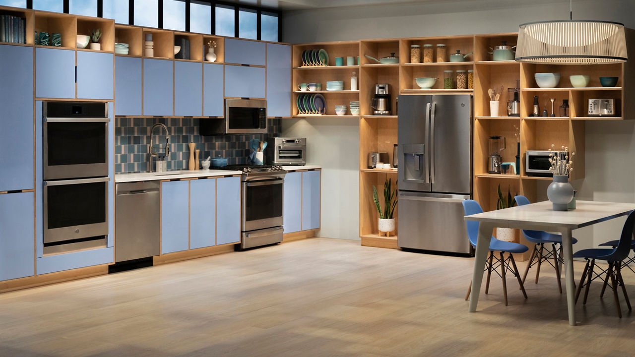 a kitchen with baby blue cabinets, wooden open cabinets and trim, modern GE appliances, and white quartz countertops.