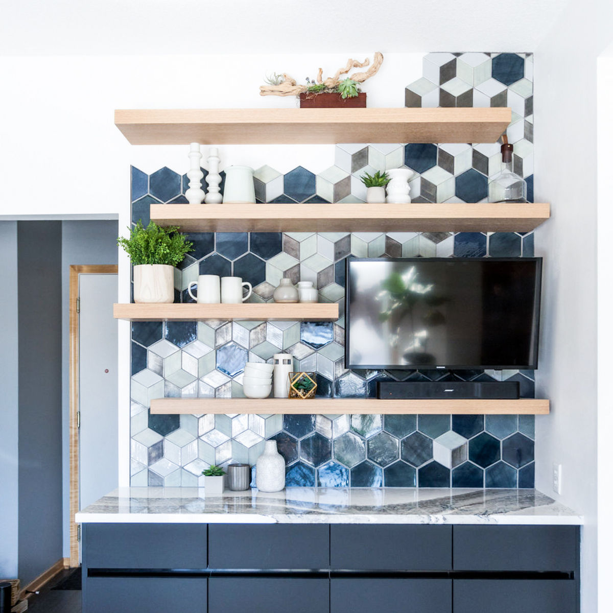 A mod mini bar with Skara Brae quartz and geometric tile on the wall.