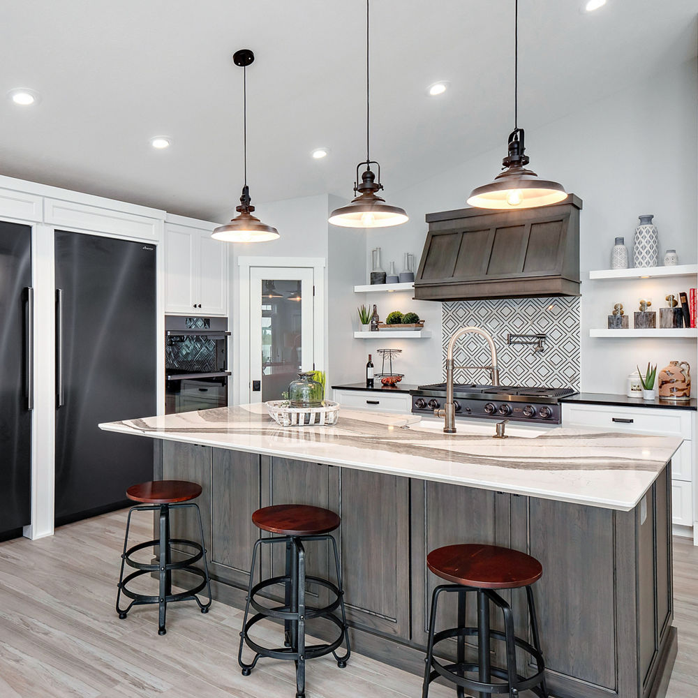 Kitchen featuring an island and white cabinetry. A counter has a Cambria Black quartz countertop.