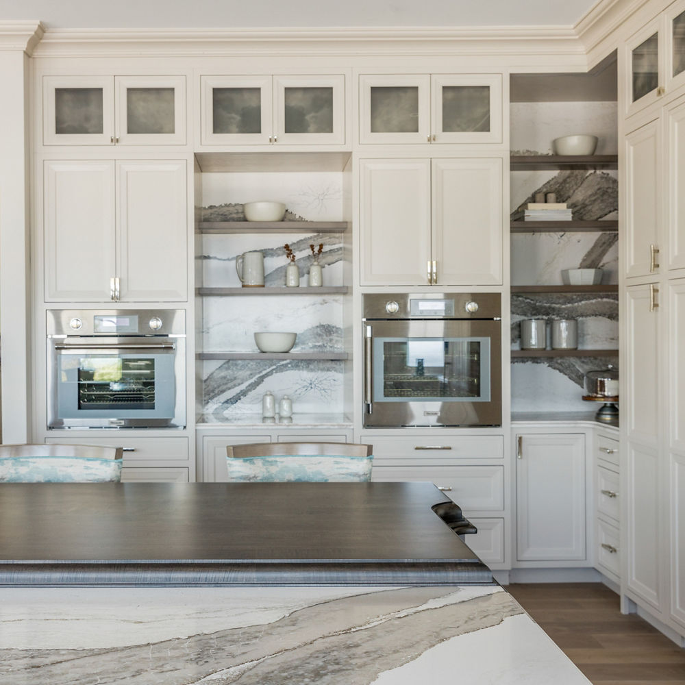 Kitchen with muted colors featuring a table and backsplash with Cambria Skara Brae quartz.