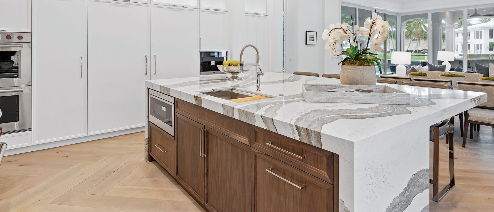 Cambria Skara Brae quartz island countertops in an all-white kitchen space.