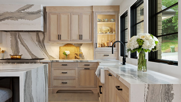 Kitchen featuring a counter and island with Cambria Skara Brae quartz countertops and siding.