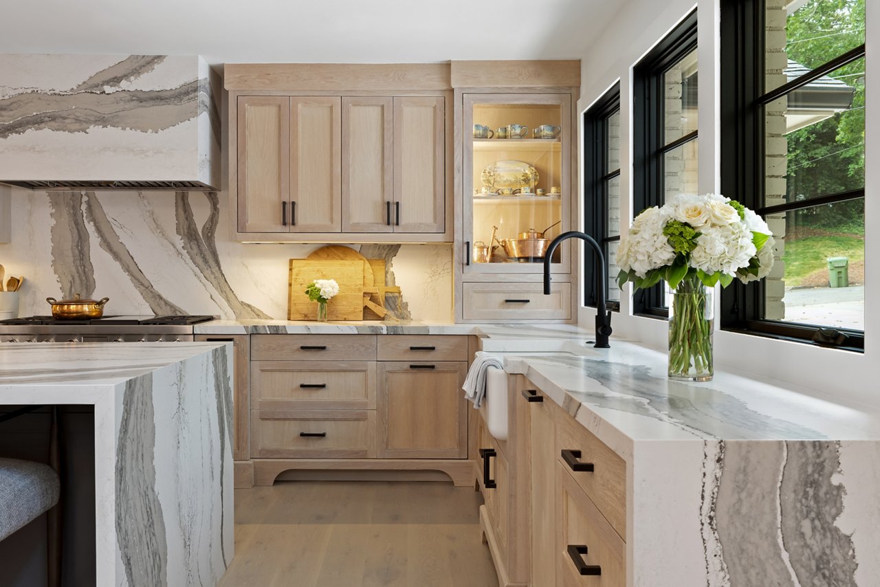 Kitchen featuring a counter and island with Cambria Skara Brae quartz countertops and siding.