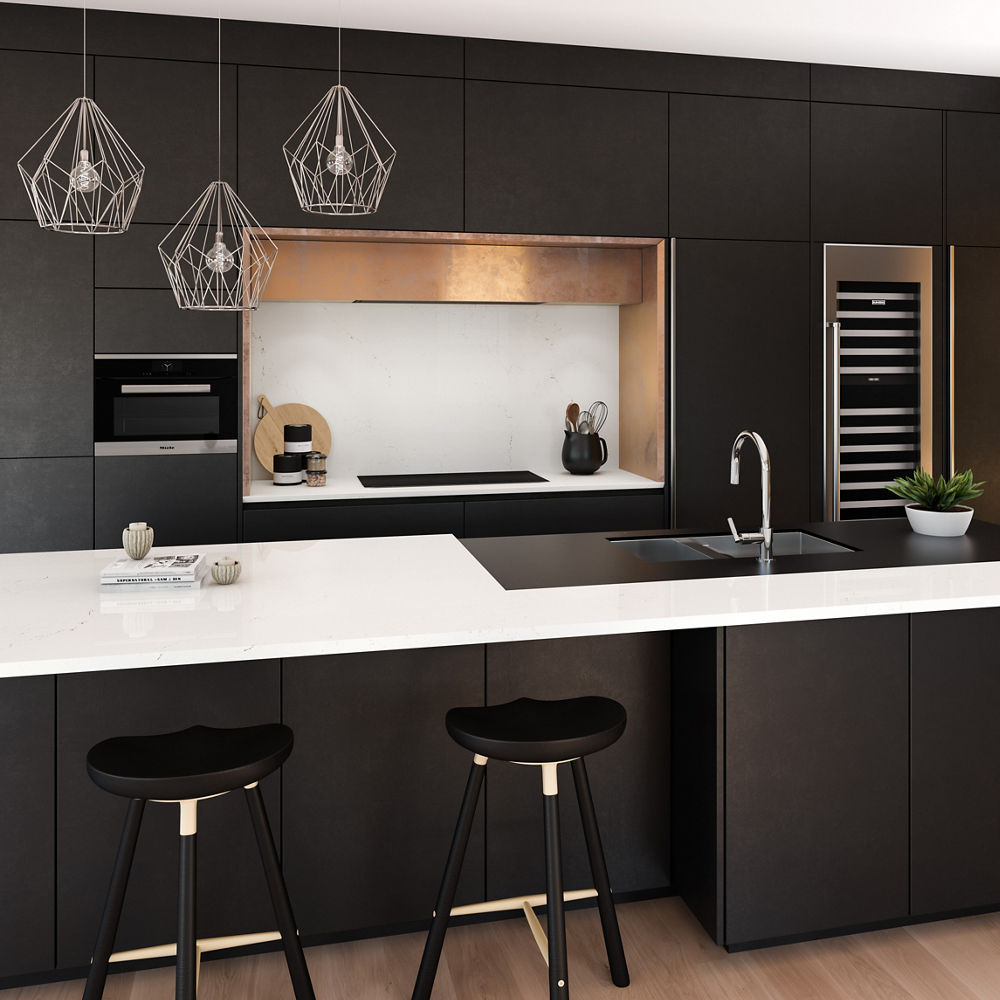 a modern black kitchen with black cabinets, two black barstools, white quartz countertops, and gold accents around the fridge and stove.