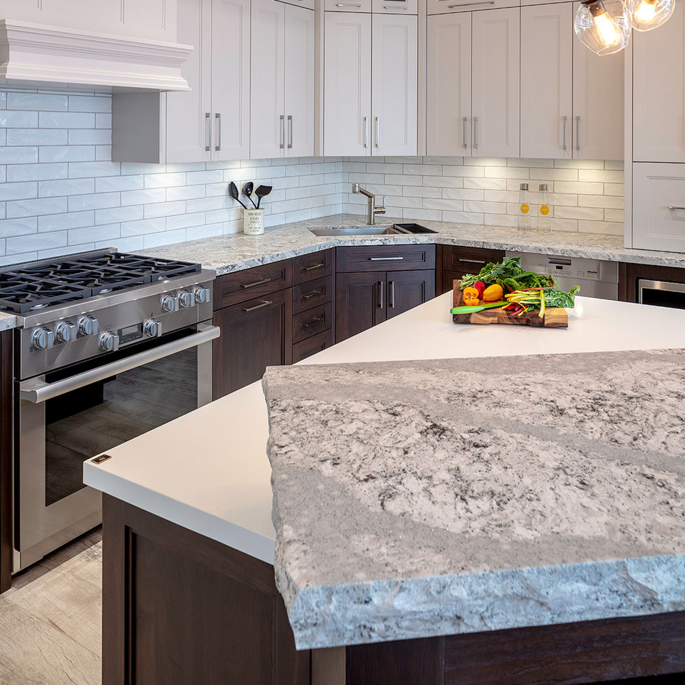 Light kitchen with white tile backsplash, white cabinets, and light Summerhill quartz countertops