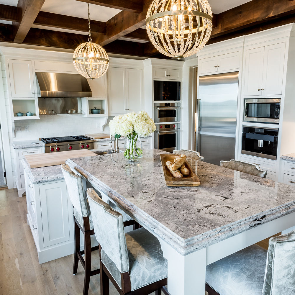 A kitchen with white cabinets, wooden beams on the ceiling, and Summerhill quartz countertops 