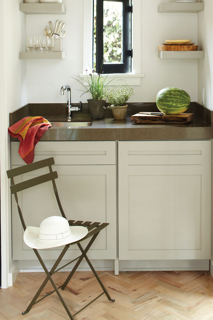 A butler's pantry with under-counter refrigerator and dove-gray cabinet topped with Sussex gray Cambria counters