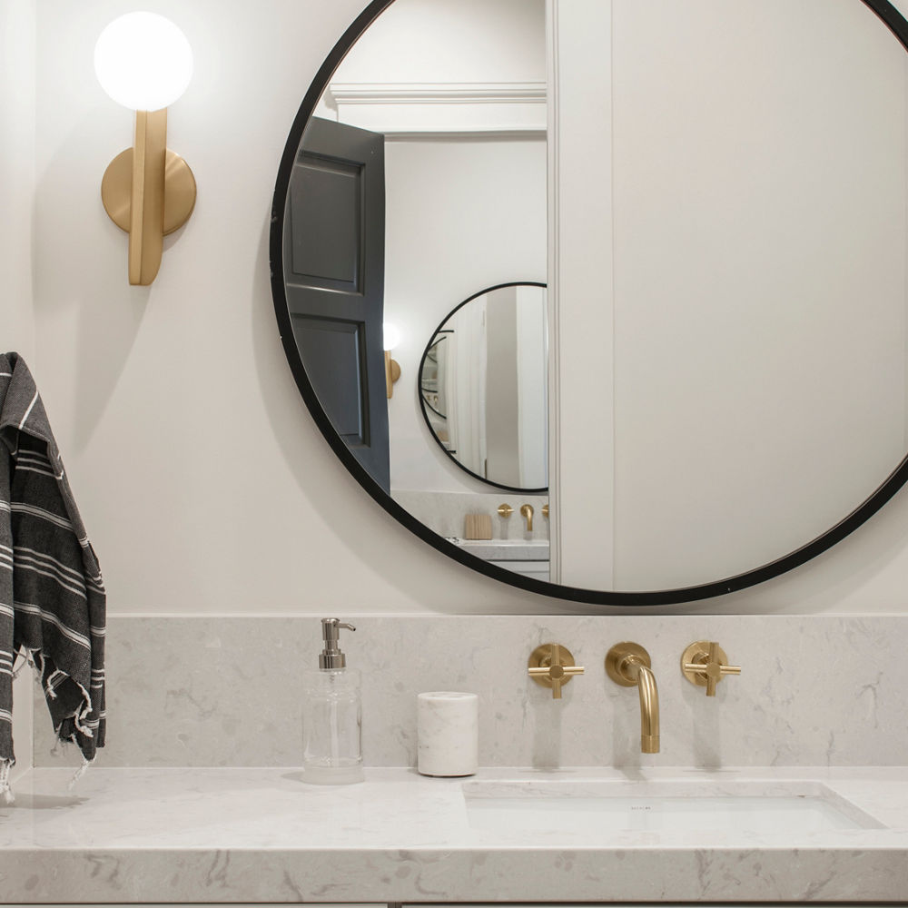 A white bathroom vanity with Swanbridge quartz countertops