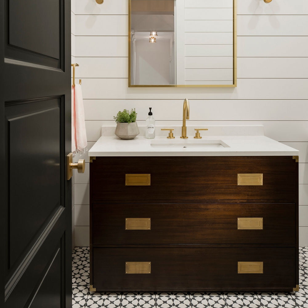 A farmhouse bathroom with dark brown wood and Swanbridge quartz countertops