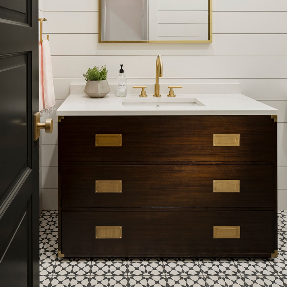A white and wood themed bathroom accented by a Cambria Swanbridge quartz countertop sink