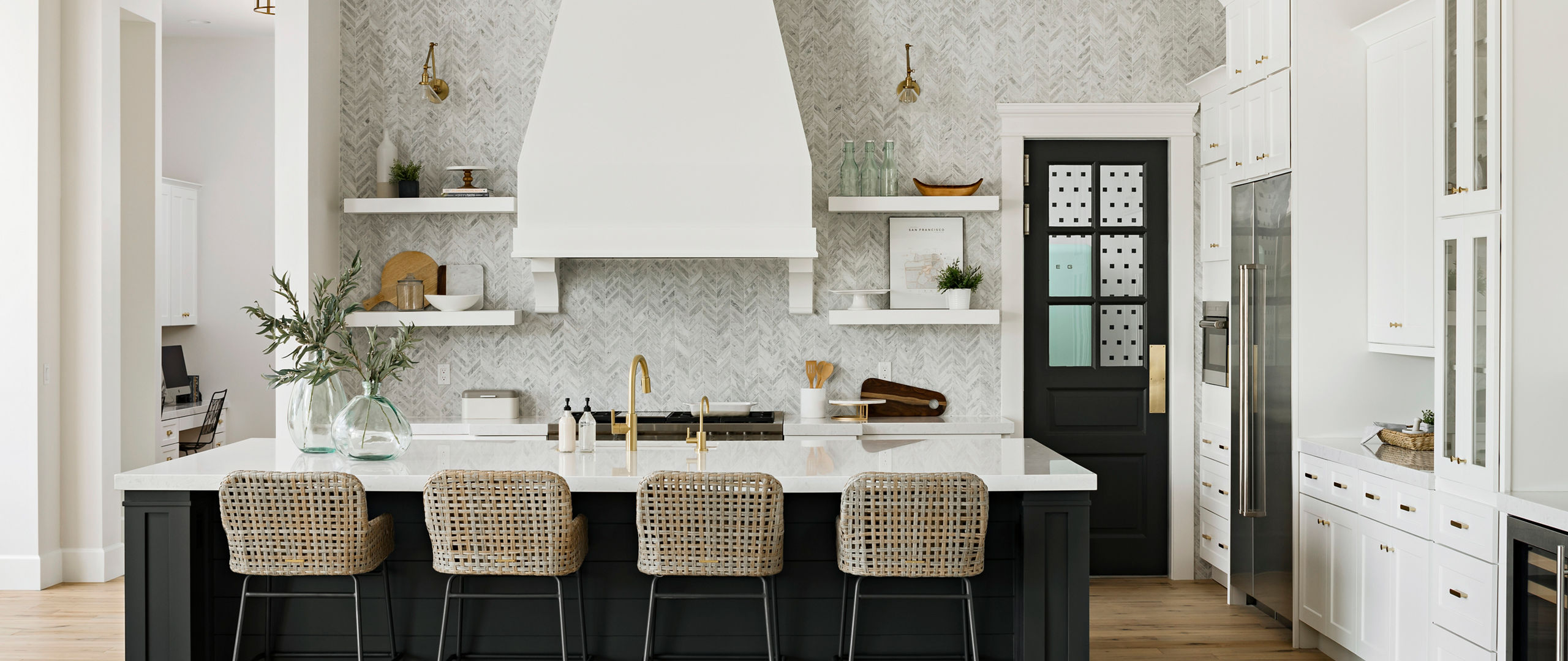 Bright white kitchen with a title wall backsplash and Swanbridge quartz countertops