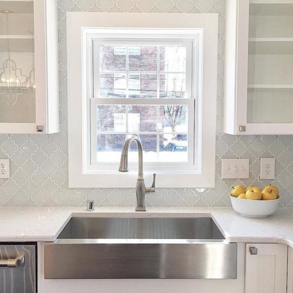 Stainless steel farmhouse sink, arabesque tile, and Swanbridge countertops