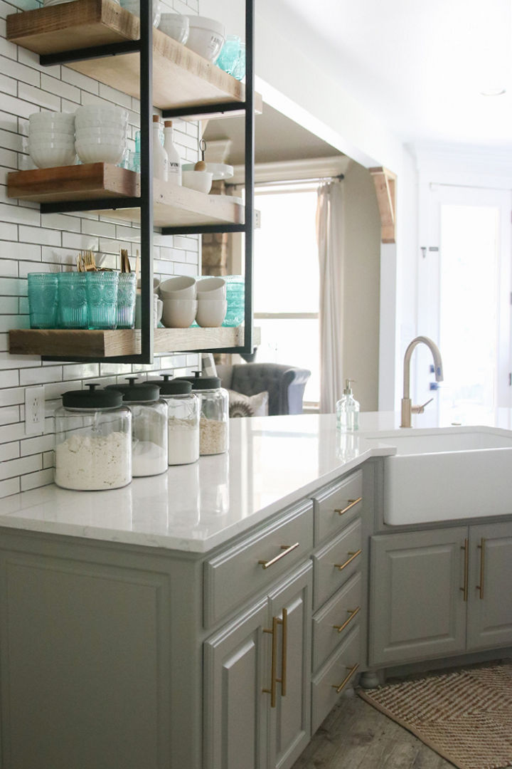 Cambria Swanbridge quartz countertop with grey and brass cabinetry underneath