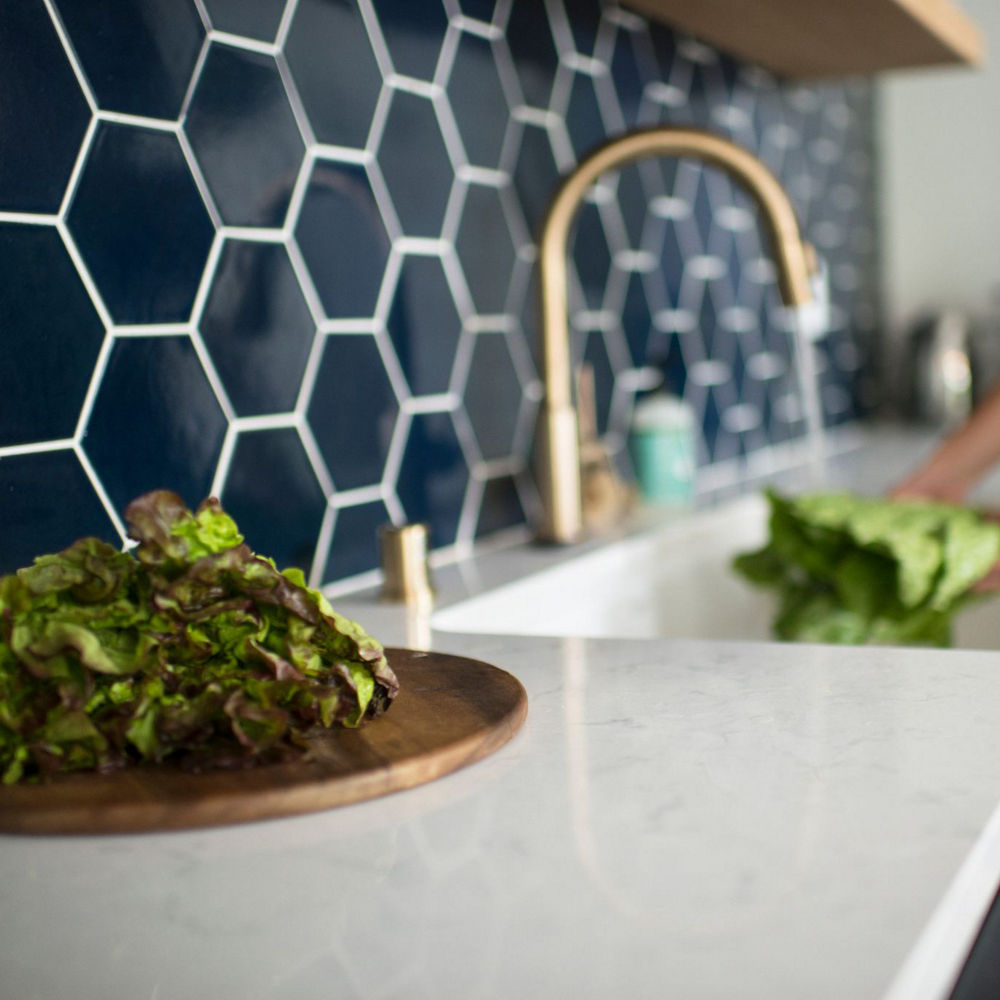 A sink with washed produce and Swanbridge quartz countertops