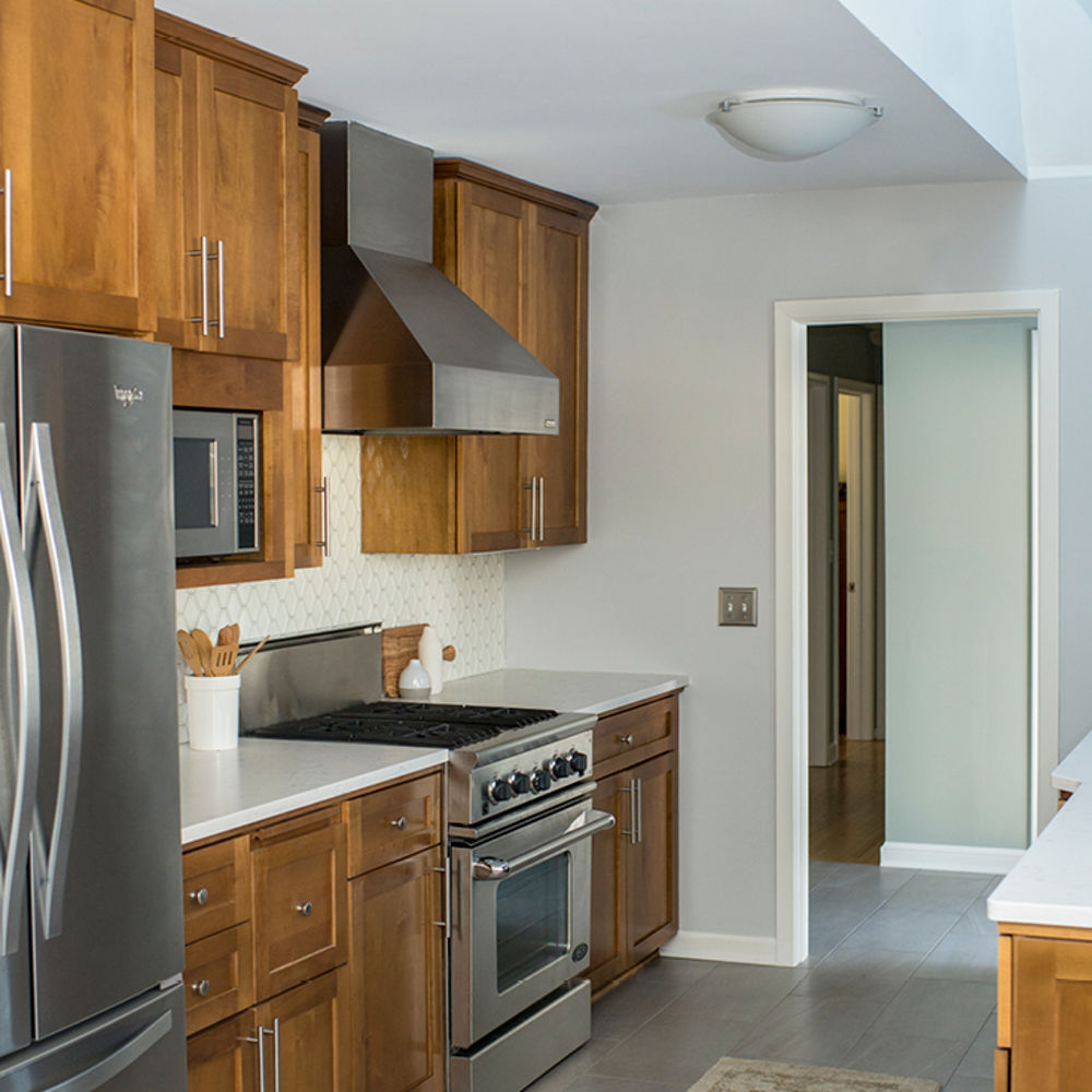 A kitchen with warm wood cabinets and Swanbridge Matte countertops.