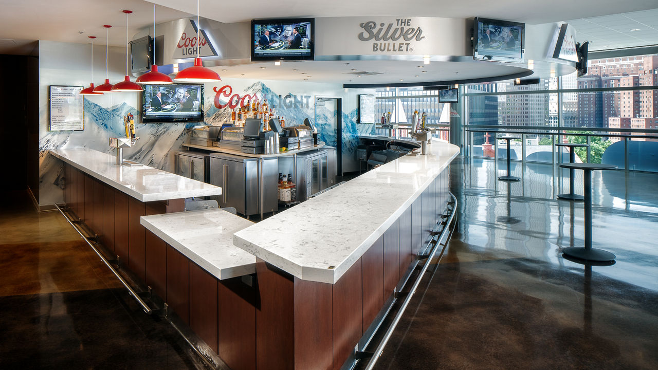 a wooden bar in PPG Paints Arena topped with white quartz countertops. 