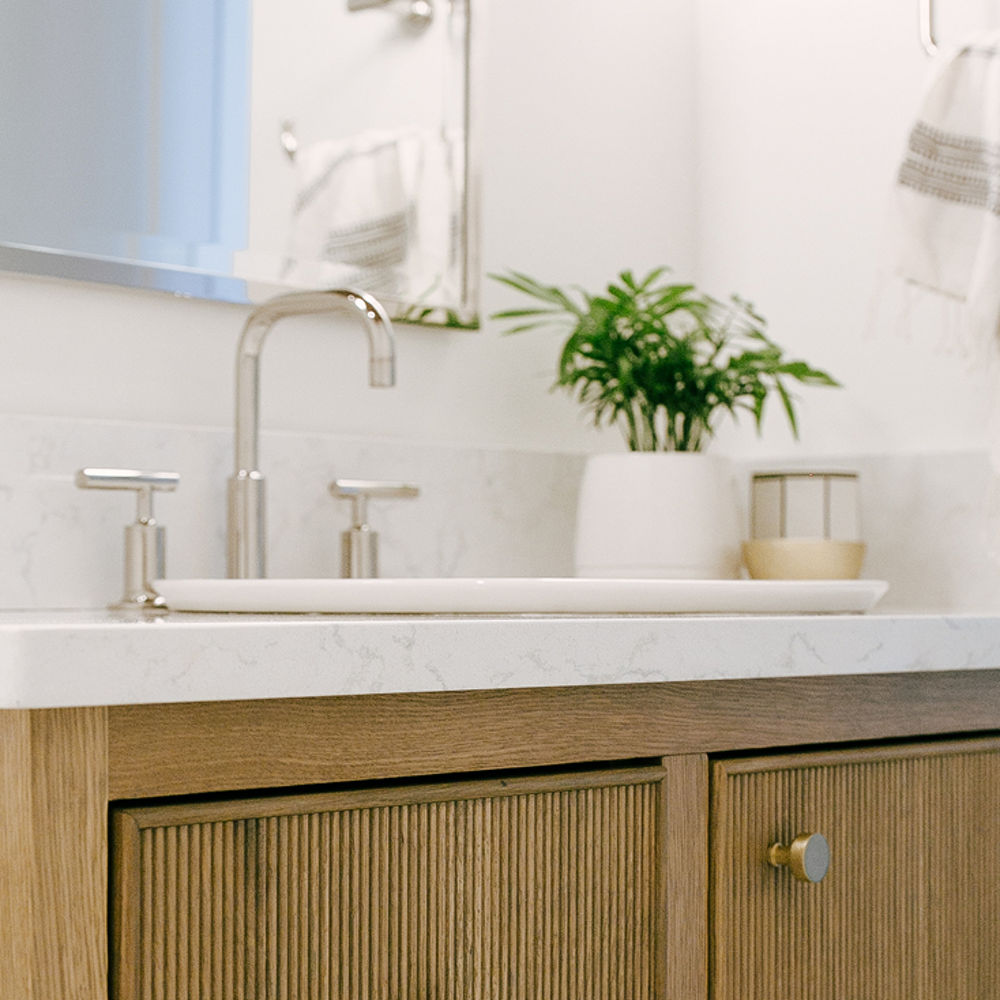 A vanity inside of a powder room featuring a Cambria Torquay quartz countertop.