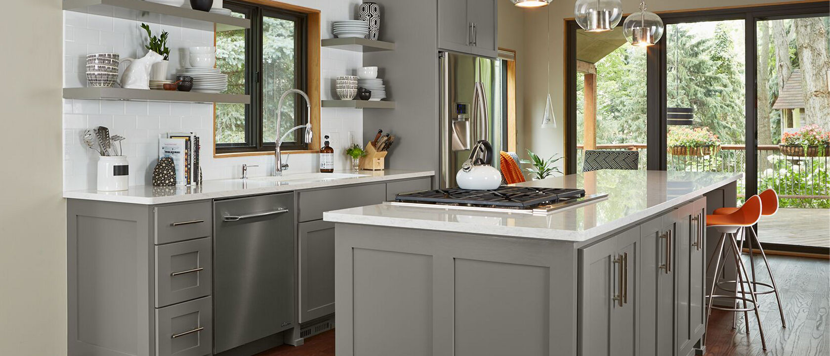 Kitchen with gray cabinetry on a kitchen counter and island with Cambria Torquay quartz countertops.