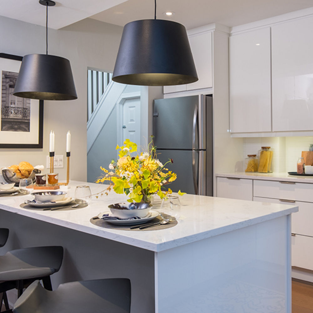 A kitchen with a peninsula kitchen layout and Torquay quartz countertops