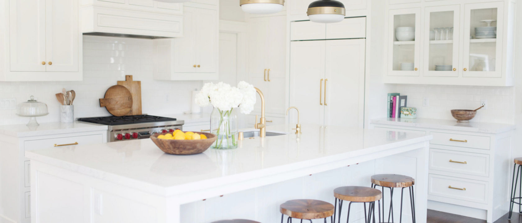 Bright white kitchen with gold accents featuring Torquay quartz countertops