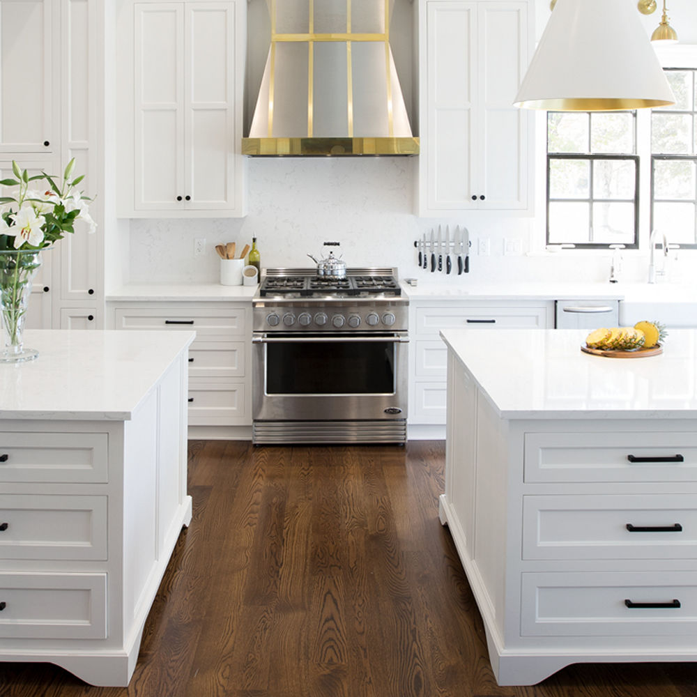 Kitchen with double islands featuring Cambria Torquay quartz countertops with an oven between both islands.