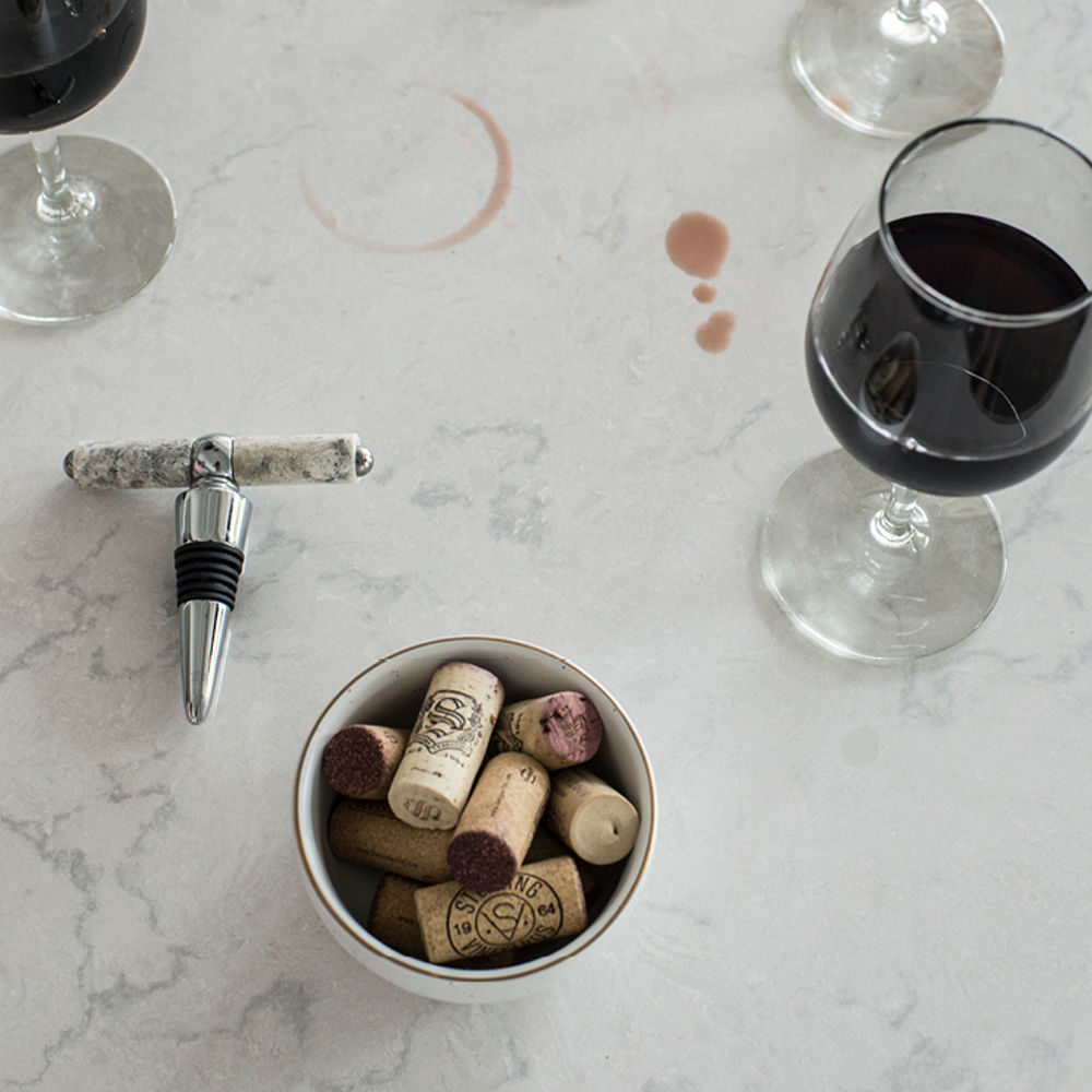 Stain-resistant Torquay quartz countertops shown by wine spill