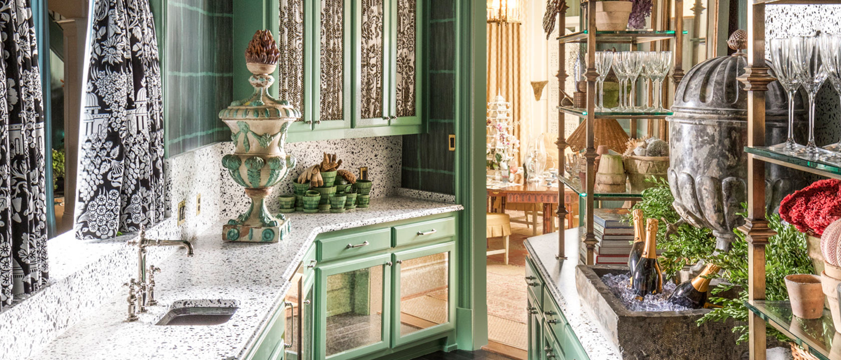 Kitchen with green cabinetry and two counters with Cambria Vail Village Matte quartz countertops.