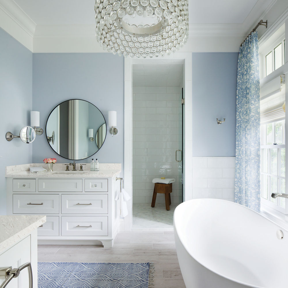 Weybourne Bathroom Countertops in an elegant, blue bathroom with white cabinetry