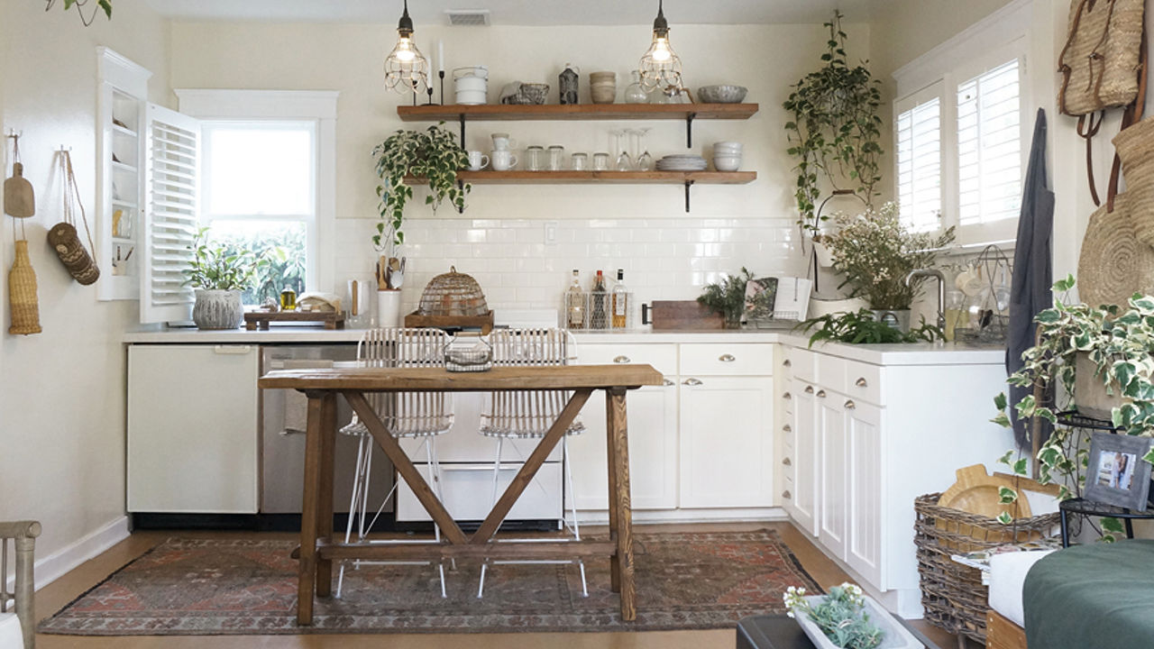 White kitchen decorated with plants and Cambria Weybourne Matte quartz counterotps.