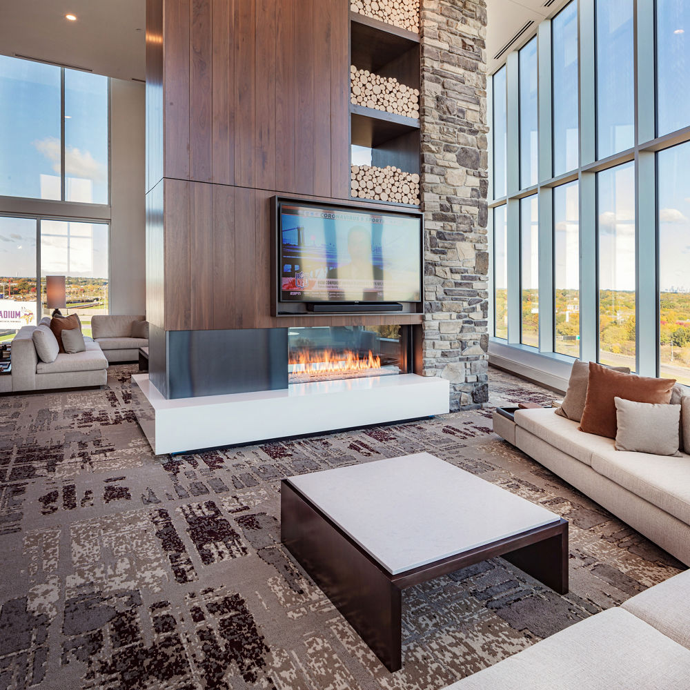 Presidential suite with a table and fireplace hearth with Cambria White Cliff quartz.