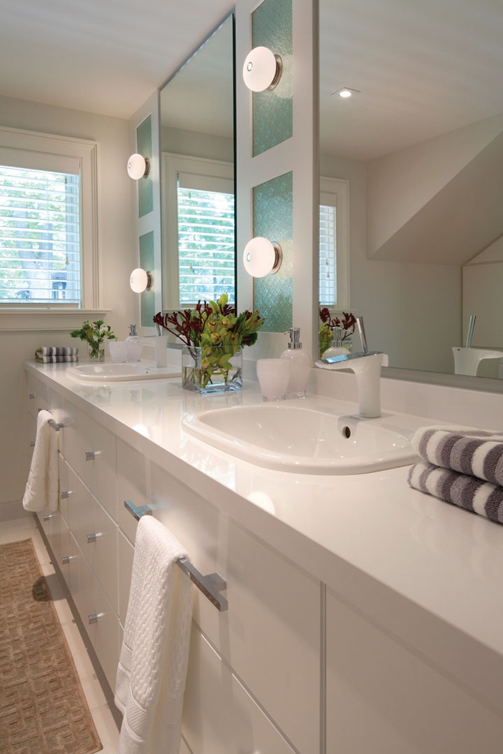 a bathroom with double sinks, white cabinets, white quartz countertops, and two large mirrors. 